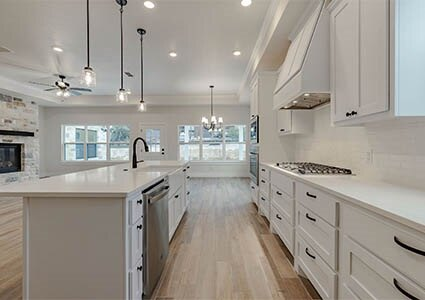 Custom cabinetry, quartz countertops, and stainless-steel appliances