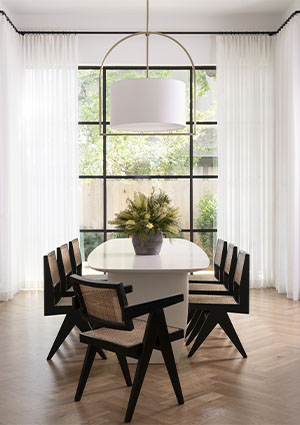 Laid-back upscale contemporary dining room with hardwood floors and floor-to-ceiling windows