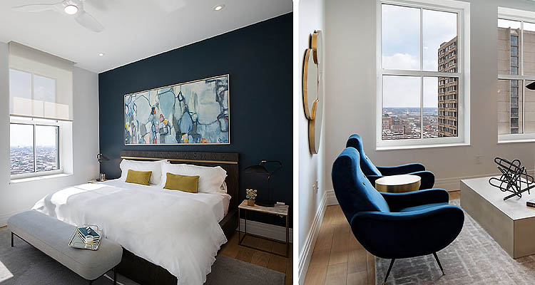 Bedroom with artwork above the bed & 2 blue chairs in a sitting room