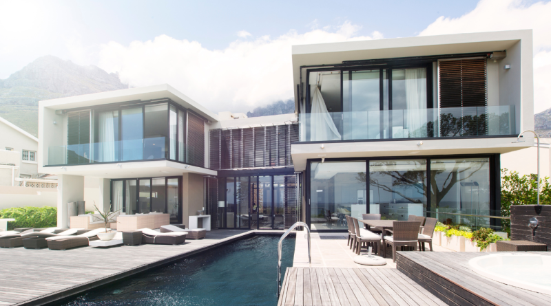 A breathtaking modern mansion with sleek architecture and a pool.