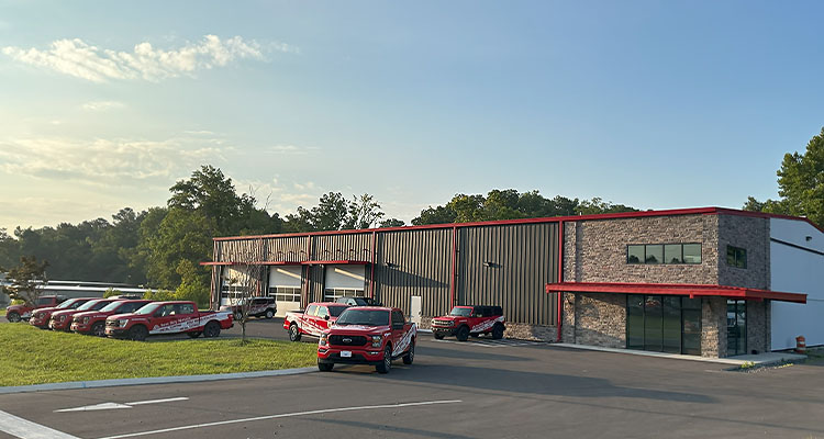 Outside a Bets Buy Metals facility with their red & white pickup trucks