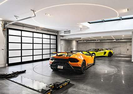luxurious 10-car garage with two Lamborghini Huracans parked inside