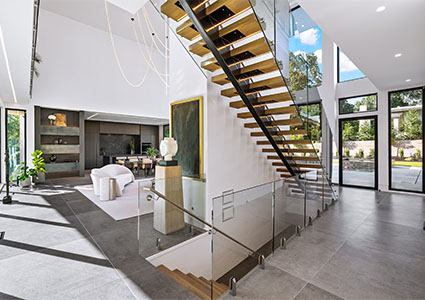modern interior featuring a staircase with glass balustrades