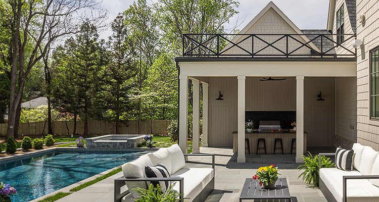 luxurious outdoor living space featuring a swimming pool and a patio area with an outdoor kitchen