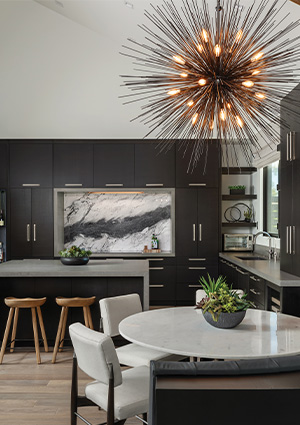 a contemporary kitchen or bar area featuring dark cabinetry and a striking sputnik-style pendant light fixture with numerous illuminated bulbs.