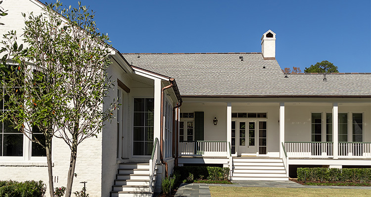 From Louisiana to New Orleans, the spotlight shines on Scheffy for true homebuilding greatness a large, traditional-style house with white painted brick walls and a light grey shingled roof
