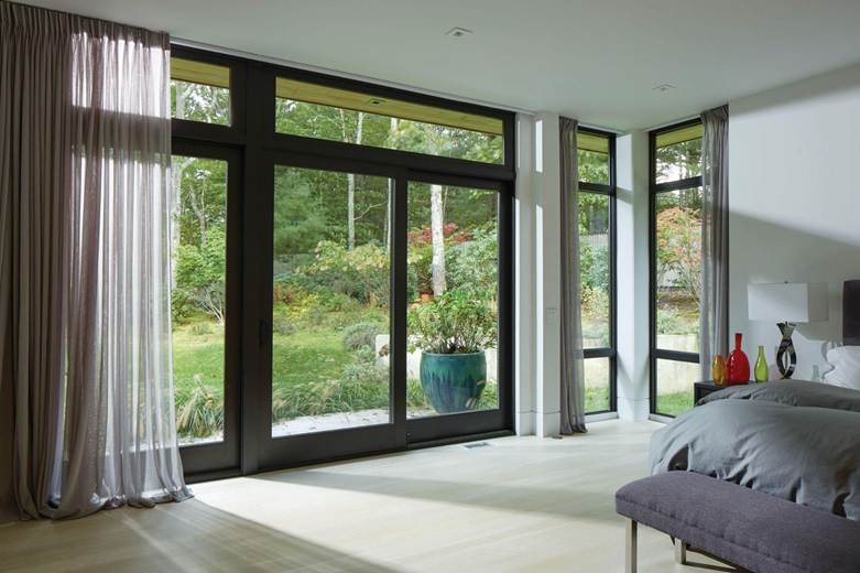 Glass doors and windows in modern home by California Energy Consultant Service