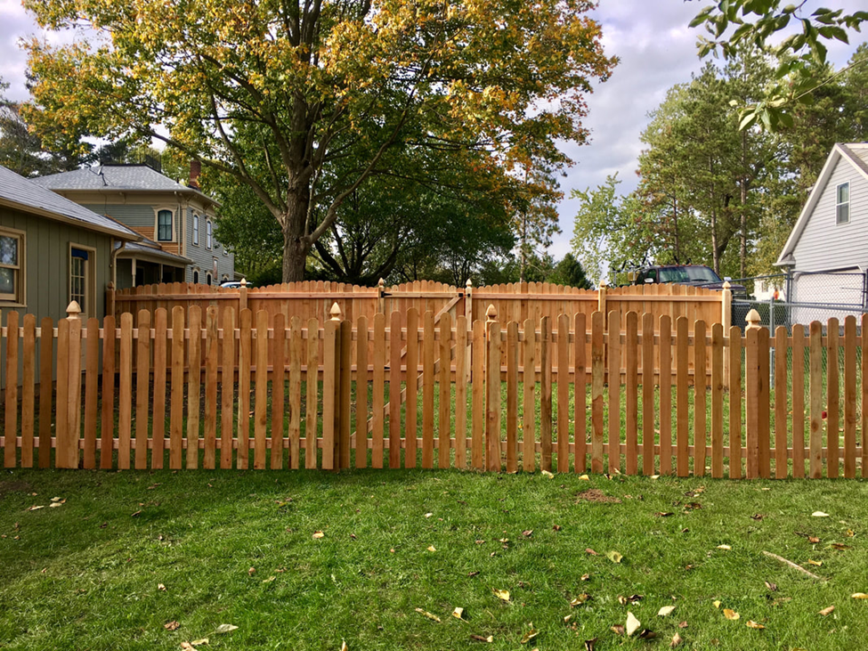 Wooden fence in garden by Cedar Mountain Fence Company