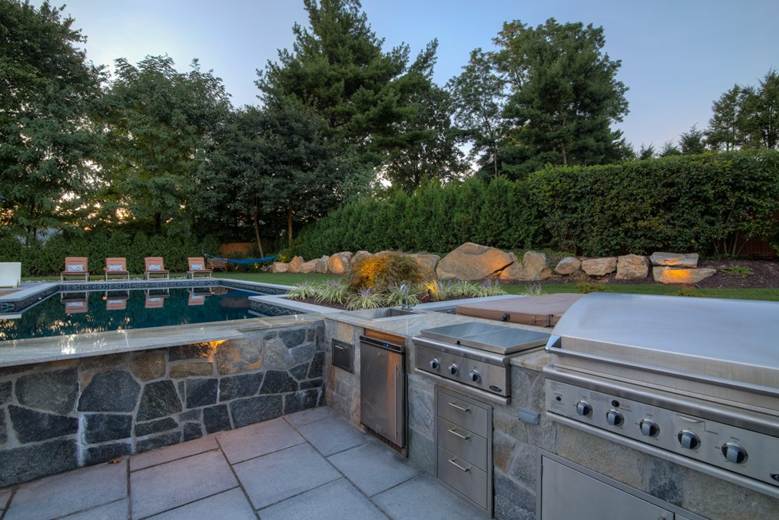 Gunite Pool with Outdoor Kitchen and Firepit by Neave Outdoor.