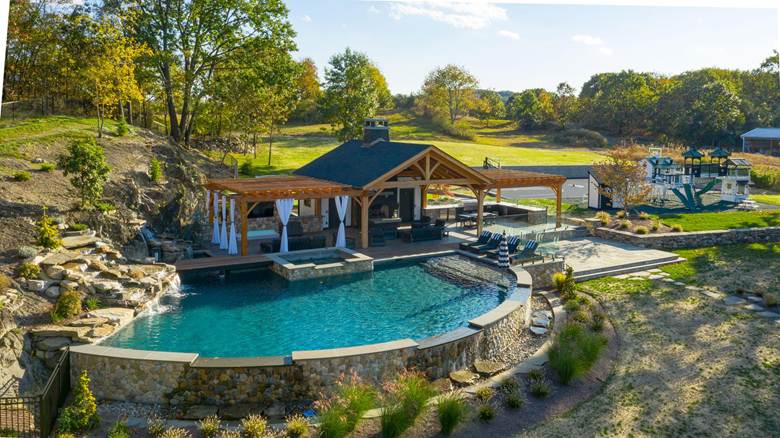 The modern, luxury poolside outdoor entertainment space by Neave Outdoor.