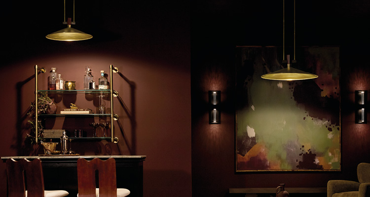 a built-in bar area features a tiered glass and brass shelving unit mounted against a dark plum or burgundy wall.