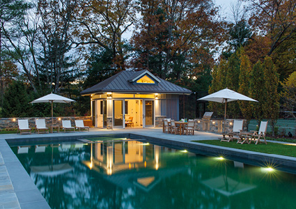a luxurious backyard pool area at dusk