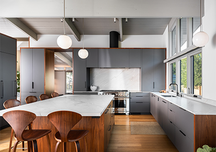 a mid-century modern design with warm wood tones, a large central island, and modern amenities like sleek cabinetry and globe pendant lighting