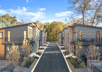 This cosy enclave features natural stone and deeper colors to blend seamlessly with the surrounding trees