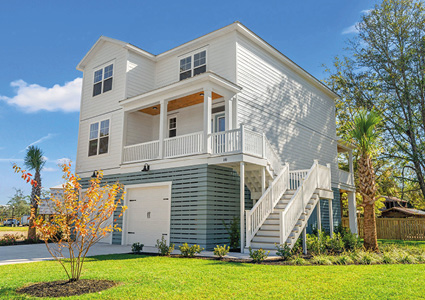 a newly constructed raised beach-style home located in a marsh-front community in Pawleys Island, SC