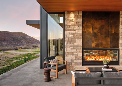 a modern, luxurious outdoor patio at dusk, designed with a warm and inviting contemporary aesthetic.