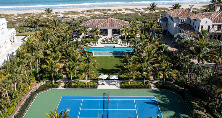 an oceanfront estate with a tennis court and swimming pool located on the coast of Florida
