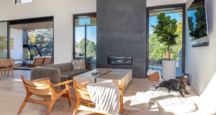a contemporary, open-concept living room designed with a warm minimalist aesthetic that seamlessly blends indoor comfort with the surrounding outdoor environment