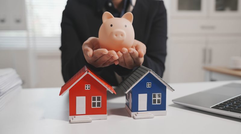 Piggy bank with two house figurines illustrating the growing divide between housing affordability and access to homeownership in America.