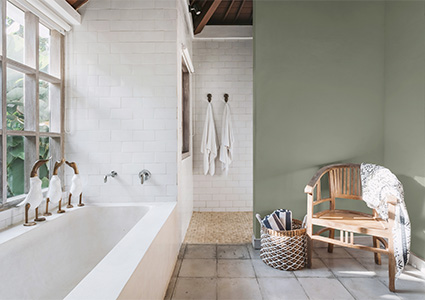 A bright white bathroom features a bathtub with duck-shaped faucets