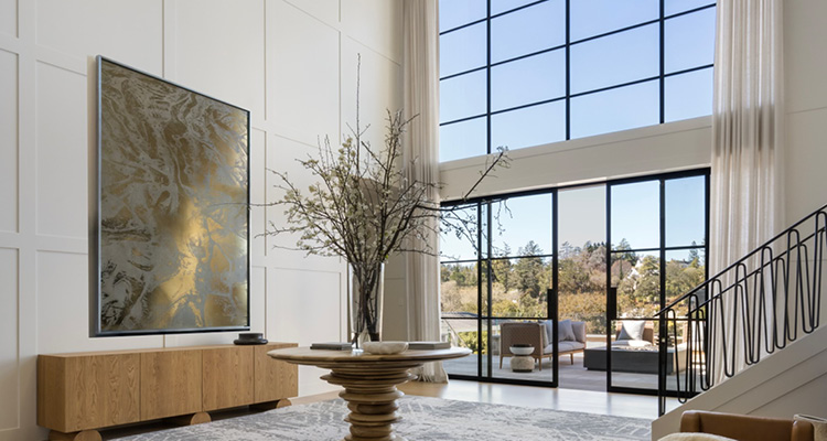 a bright, spacious, and modern luxury home entryway or living space with double-height ceilings