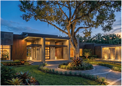 the exterior of a luxury, modern single-story home at dusk