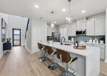 a modern, open-concept kitchen and entryway area with a clean and bright aesthetic.