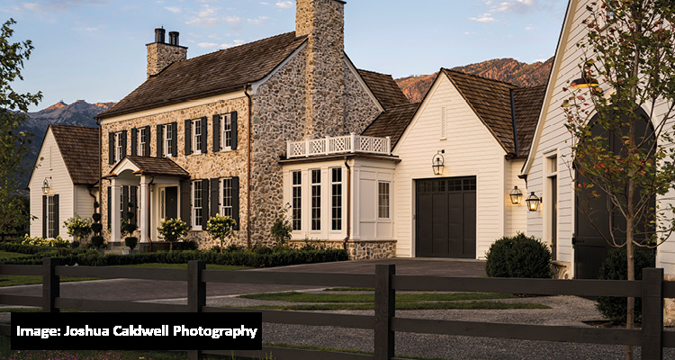a large, luxurious country estate blending classic European and American colonial architectural styles, set against a mountainous backdrop