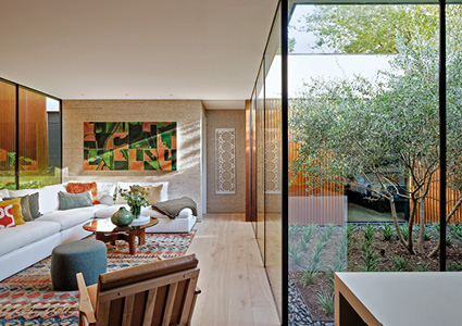 a modern, sunlit living room designed with seamless indoor-outdoor integration
