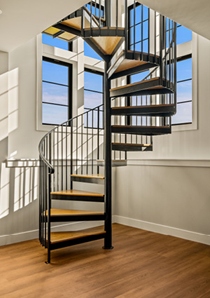 an indoor architectural scene featuring a prominent spiral staircase