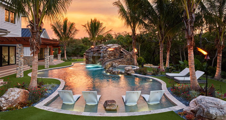 a luxurious, resort-style backyard pool area at sunset