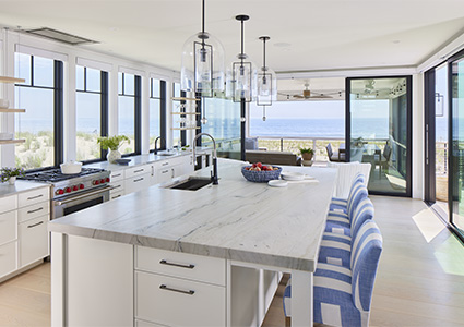 a bright, spacious, modern kitchen with an ocean view