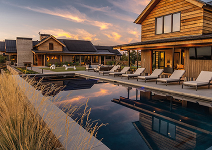a luxury modern ranch house at sunset.