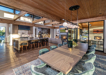 a spacious, modern, open-concept home interior featuring a dining area, kitchen, and living room