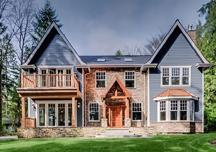 a Northwest Contemporary style luxury home featuring a stone facade and wood accents