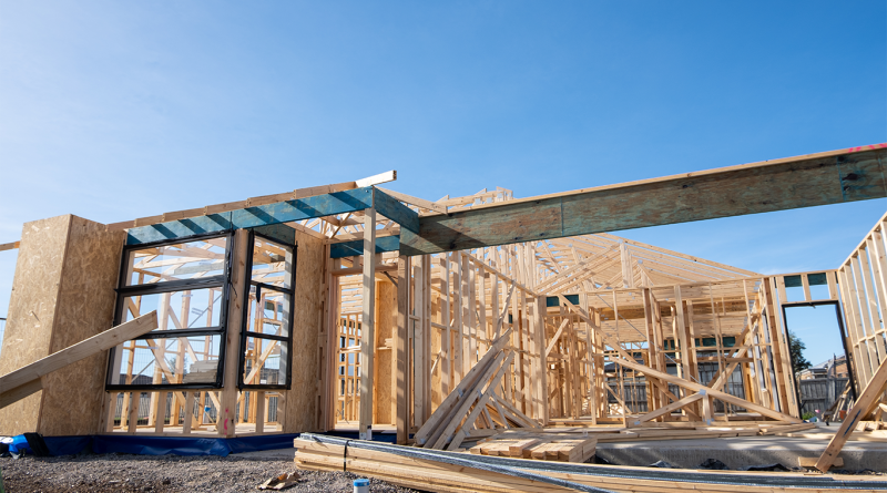 The wooden frame of a suburban house with timber trusses at a construction site