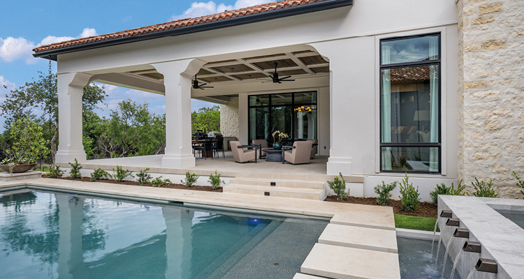 a luxury Mediterranean-style home with a large outdoor living area and a swimming pool