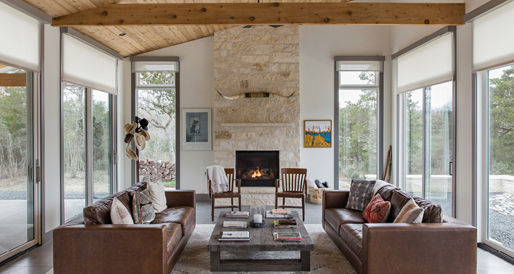 a spacious, rustic-modern living room centered around a stone fireplace