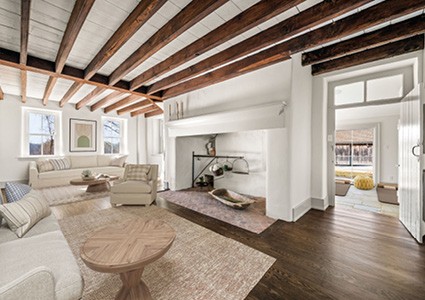 a spacious, bright living room blending rustic historic charm with modern, minimalist interior design
