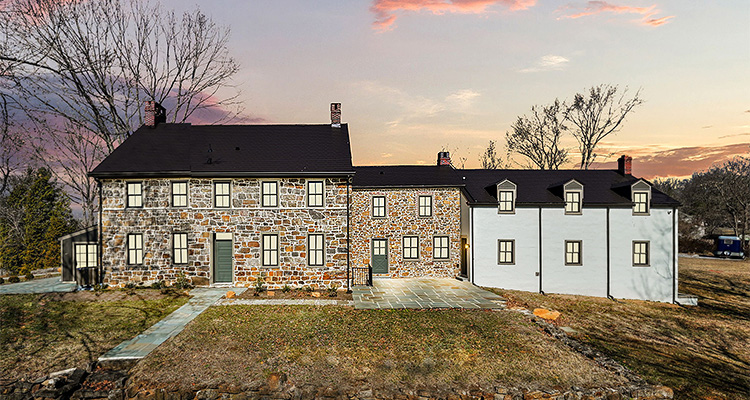 a wide, eye-level view of a large, historic-style estate under a vibrant sunset sky