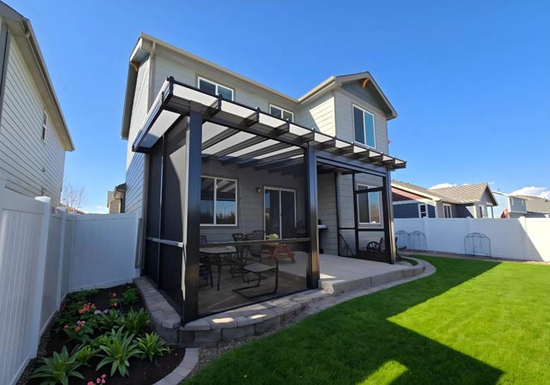 Louvered patio cover with rotating aluminum louvers and retractable mesh screens installed on a residential backyard patio. The structure features a solid roof section combined with adjustable louvers for customizable shade control.