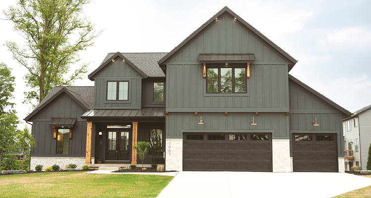 Building on 25 years of success, Buffum Homes invests in people, innovation, and West Michigan communities a modern farmhouse-style two-story home with dark vertical siding, white stone accents