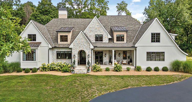 Daley Design + Build creates custom residences through design, construction, transparency, and innovation leadership a custom-built modern transitional or French Country style luxury single-family home with a mixed stone and painted brick exterior