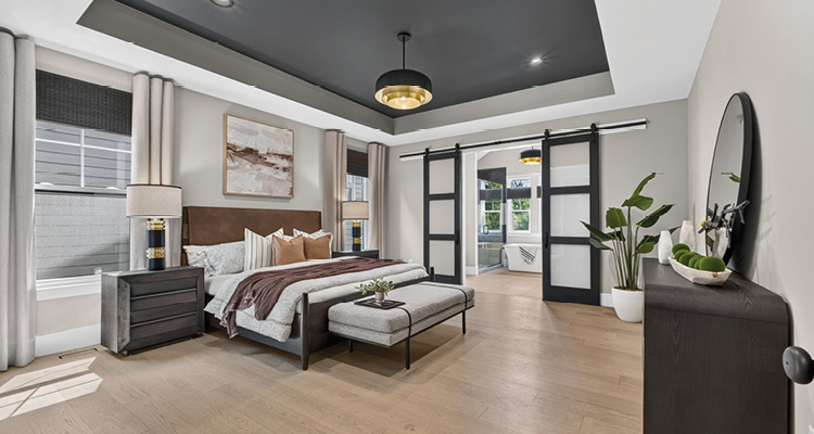How McKelvey Homes combines 125 years of heritage with forward-thinking homebuilding and lasting quality a transitional primary bedroom featuring a high-contrast palette and a recessed tray ceiling.