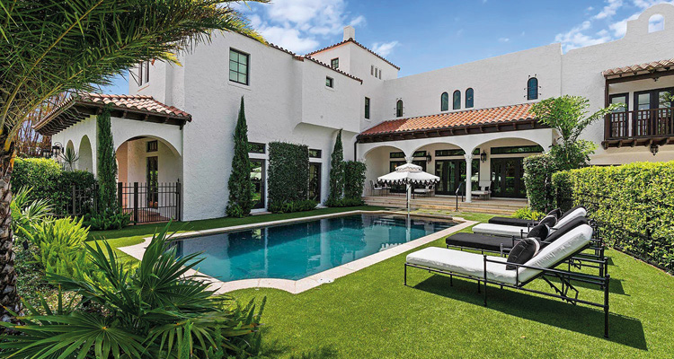 Steve Cury Construction has built a reputation for creating unique custom homes and renovation projects a luxurious residential backyard centered around a rectangular swimming pool, designed in a classic Mediterranean or Spanish Colonial Revival architectural style