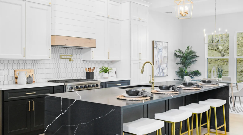 Modern custom kitchen with white shaker cabinets, dark lower cabinetry and a large central island.