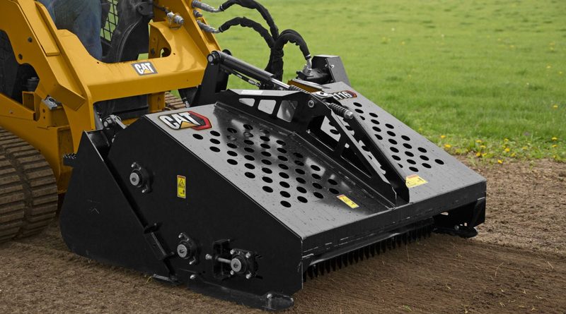 CAT compact track loader using a landscaping attachment to move a large tree root ball.