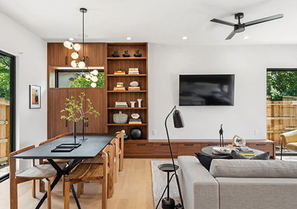 An open-concept modern living and dining area features a clean, bright aesthetic with warm wood accents and contemporary furniture