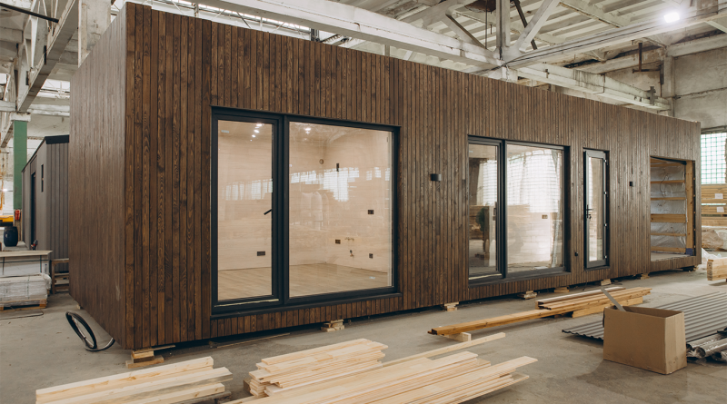Modular wooden house under construction in a large factory