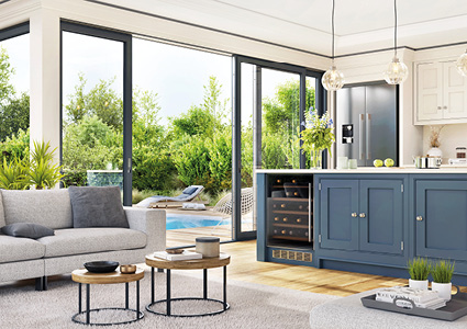 a modern, open-concept kitchen and living area that seamlessly connects to a lush backyard through large glass sliding doors